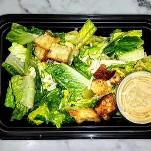 CLASSIC CAESAR SALAD: Romaine Hearts, Reggiano, Garlic Crouton, Signature Dressing.