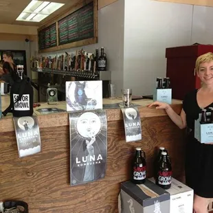 a woman standing in front of a bar