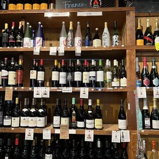a shelf full of wine bottles