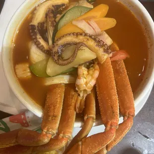 Seafood soup: scallops, fish, crab legs, mussels and octopus all in one delicious bowl! Yum!