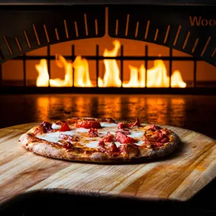 a pizza on a cutting board