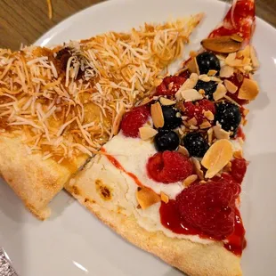 pizza dessert. one with some coconut and one with some berries.