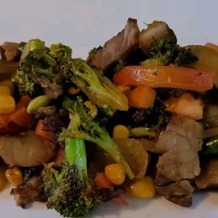 Steak and vegetables over white rice