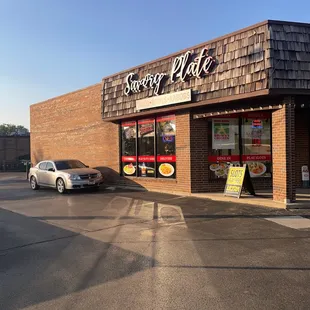 a car parked in front of a restaurant