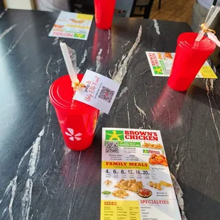 a table with a menu and drinks