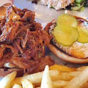 a pulled pork sandwich and french fries