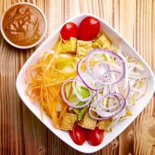 Thai salad;  Iceberg lettuce, grape tomatoes, beansprout, red onion, carrot, fried tofu and peanut dressing!