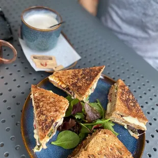 a plate of sandwiches and a cup of coffee