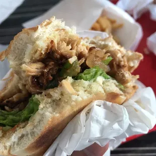 a hand holding a sandwich