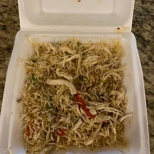 a take out container of noodles