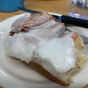 Yummy cinnamon roll in progress of being devoured