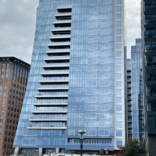 a tall building with a blue glass facade