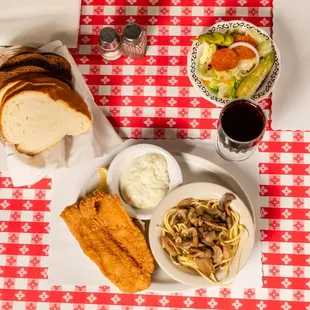 a plate of pasta, bread, and a glass of red wine
