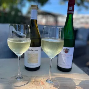 two glasses of wine and a bottle of wine