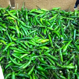 a box full of green peppers