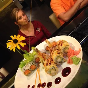 a sushi platter with sushi and sauces