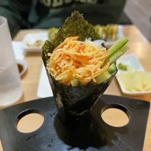 a person sitting at a table with a plate of food