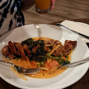 Duck Curry (Duck had crispy skin, and coconut red curry was savory 5/5) served with side of rice.