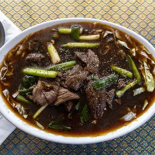 a bowl of beef and asparagus soup