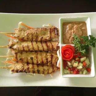 Satay-Gai Grilled marinated coconut curry chicken, peanut sauce,cucumber relish.