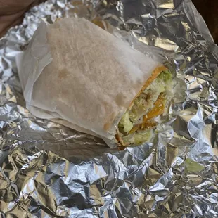 a burrito wrapped in aluminum foil