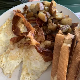 Three eggs over easy bacon taters toast