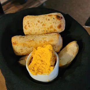 a plate of bread and a bowl of mustard
