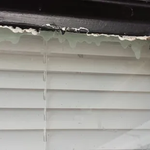 Typical painted edge of glass/windows. Displays total lack of concern for the quality of the property.