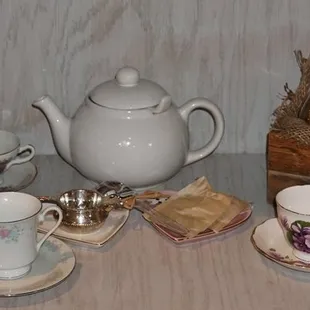 teapot, teacups, saucers, and tea bags