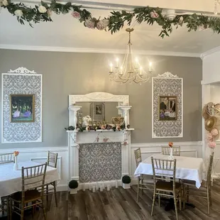 Our lovely, newly restored front of tearoom with antique fireplace surround, wainscoting, damask moldings, and more!