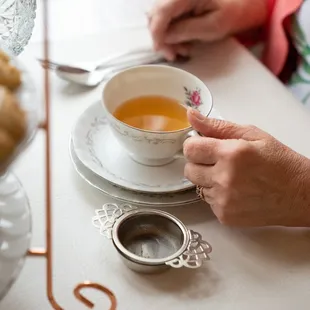 a woman holding a cup of tea
