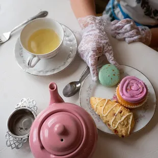 a teapot, cupcakes, and a plate of cookies