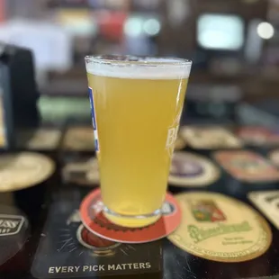 a pint of beer on a coaster
