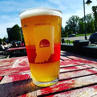 a pint of beer on a wooden table