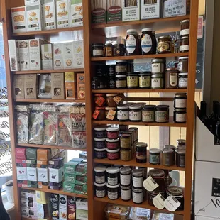 a shelf full of cheeses and condiments