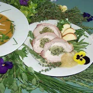 Herb stuffed loin of pork with apple sauce and carrot clove soup