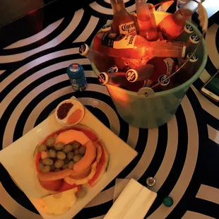 a bowl of fruit and snacks on a table