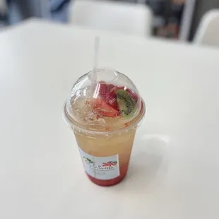 a fruity drink in a plastic cup