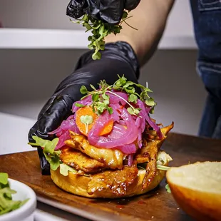 a person preparing a sandwich