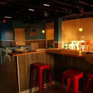 a bar with red stools