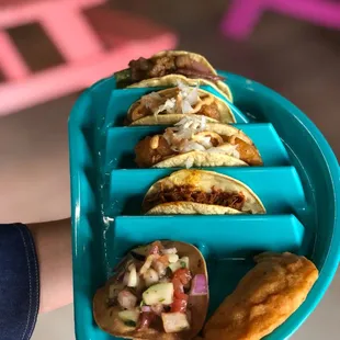 five tacos on a blue tray