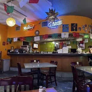 a restaurant with tables, chairs, and a bar