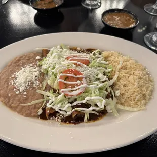 Enmolada entree with rice and beans