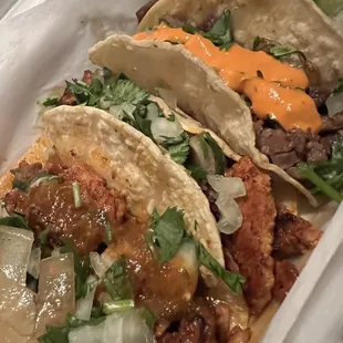 three tacos in a styrofoam container