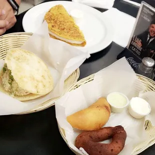 Cachapa, arepa pepiada, empanada de carne(meat empanada), mandoca with nata and Wasakaka (green) sauce.