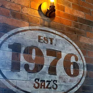 a brick wall with a sign on it