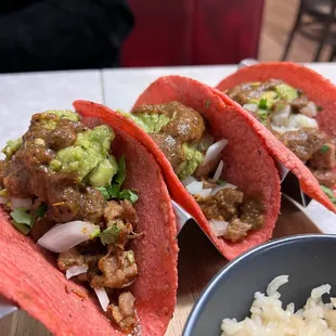 three tacos on a table