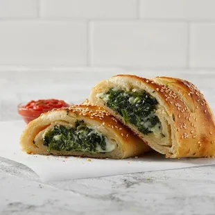 a close up of a sandwich with spinach and cheese