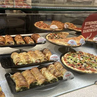 a variety of pizzas on display