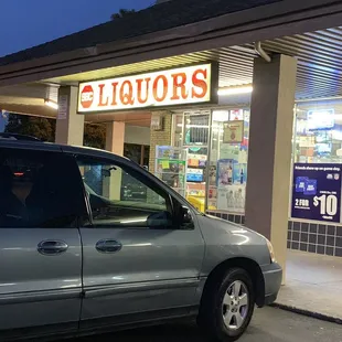 a car parked in front of a liquor store